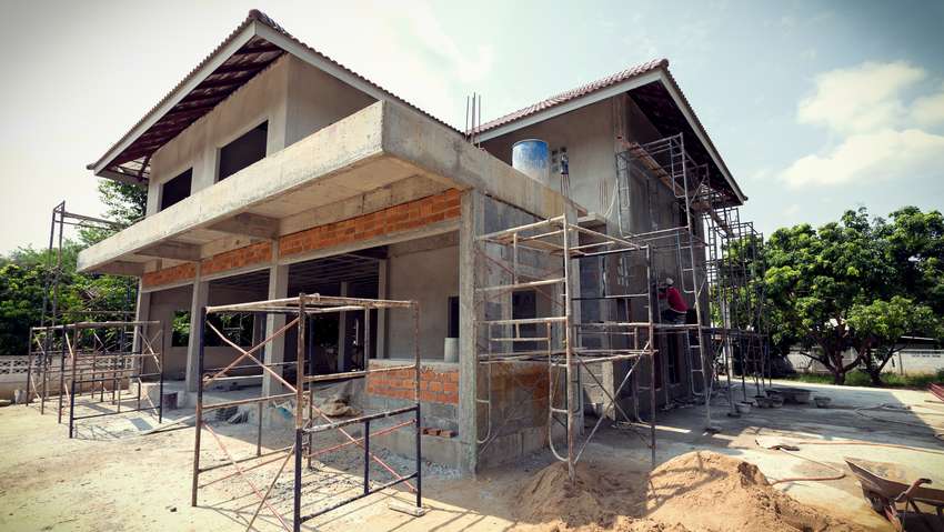 building residential construction house with scaffold steel